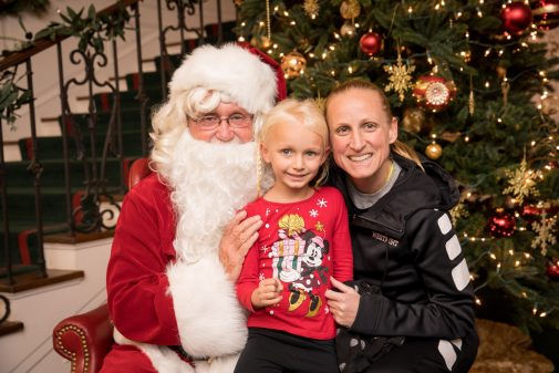 Santa poses for a picture with Alexis and Kirsten Moore